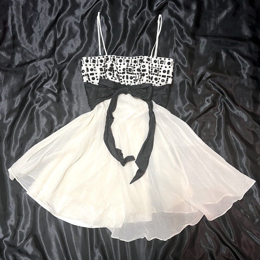 2000s flowy cream dress with a black bow and beads.